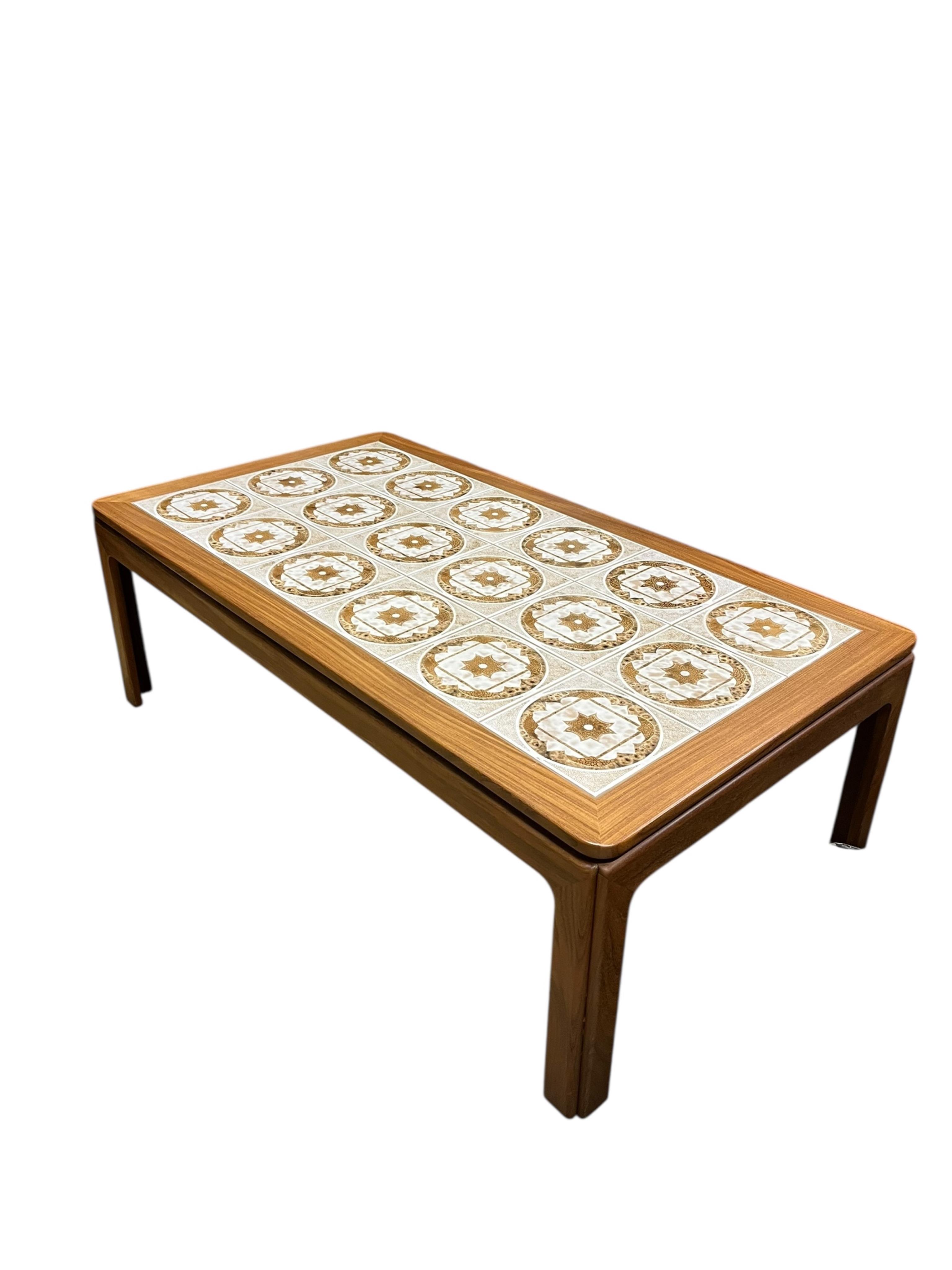 A mid century G Plan tile top teak coffee table and two matching occasional tables, larger width 134cm, depth 74cm, height 46cm